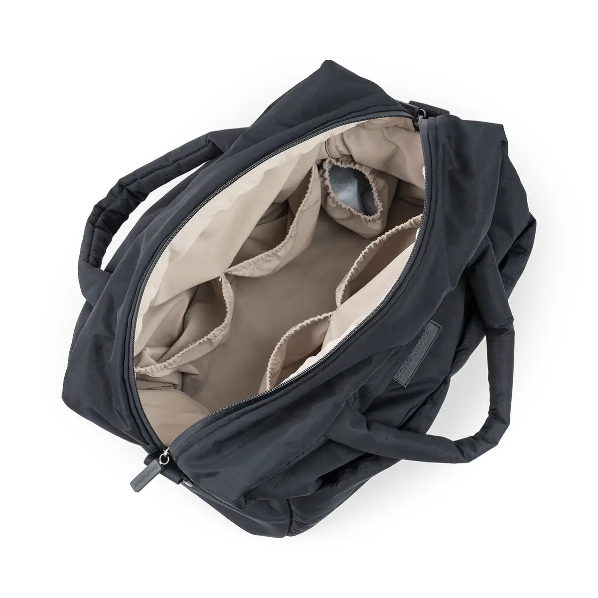The different compartments in a black quilted changing bag