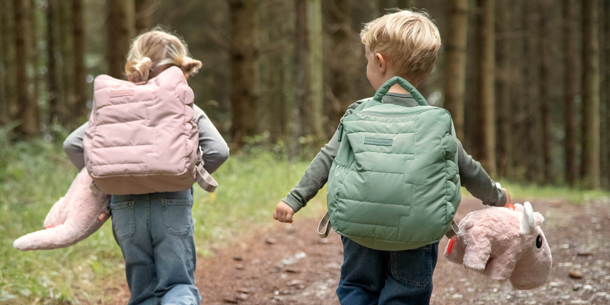 two children with Done by Deer quilted kids backpacks